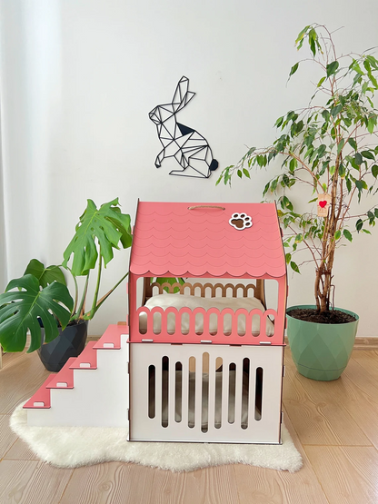 Side view of a large white and pink two-story modern wooden cat house, showcasing the roomy interior and contemporary design.