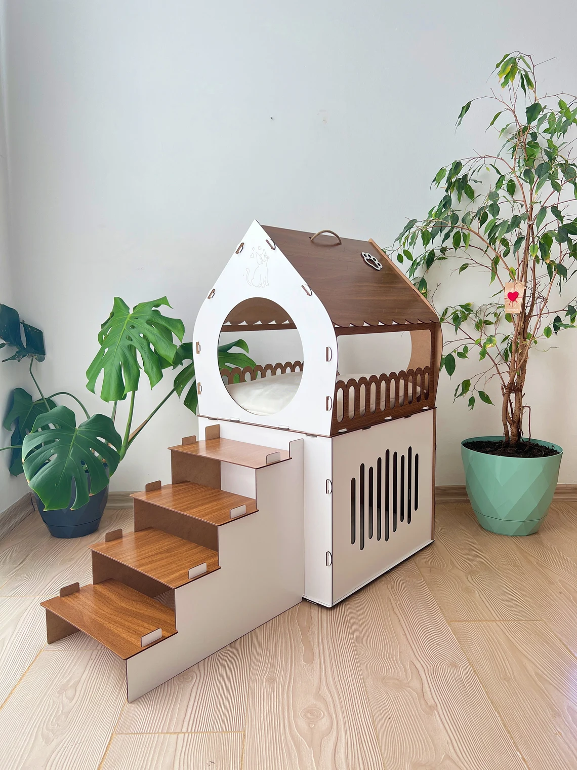 Side view of a White and Brown large two-story modern wooden cat house, highlighting the sleek design and spacious interior.