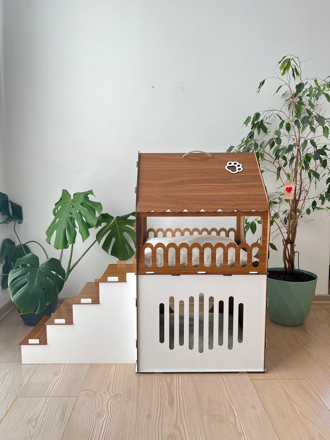 Side view of a white and brown medium two-story modern wooden cat house, highlighting the sleek design and spacious interior.