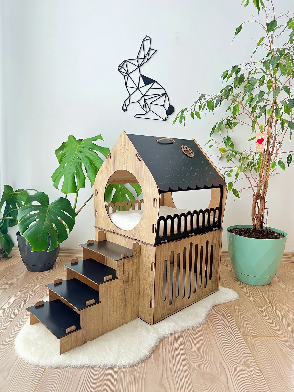 Side view of a medium black and brown two-story modern wooden cat house, showcasing the roomy interior and contemporary design.