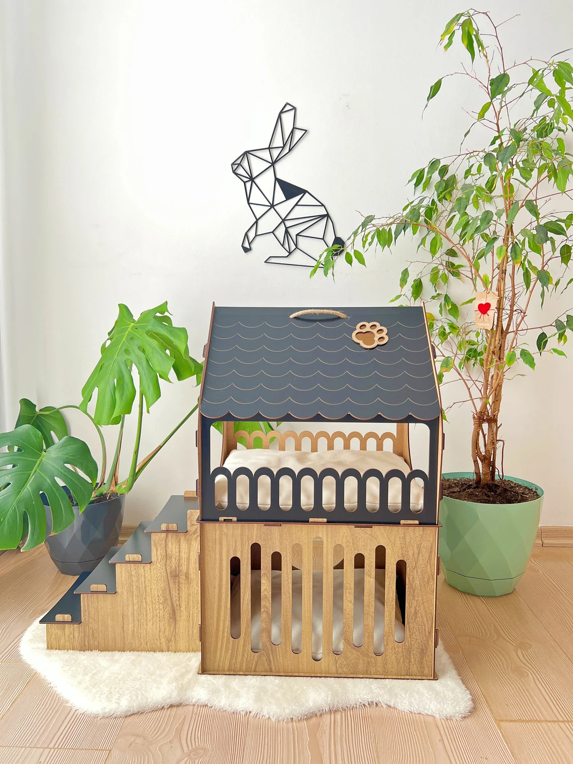 Side view of a black and brown medium two-story modern wooden cat house, highlighting the sleek design and spacious interior.