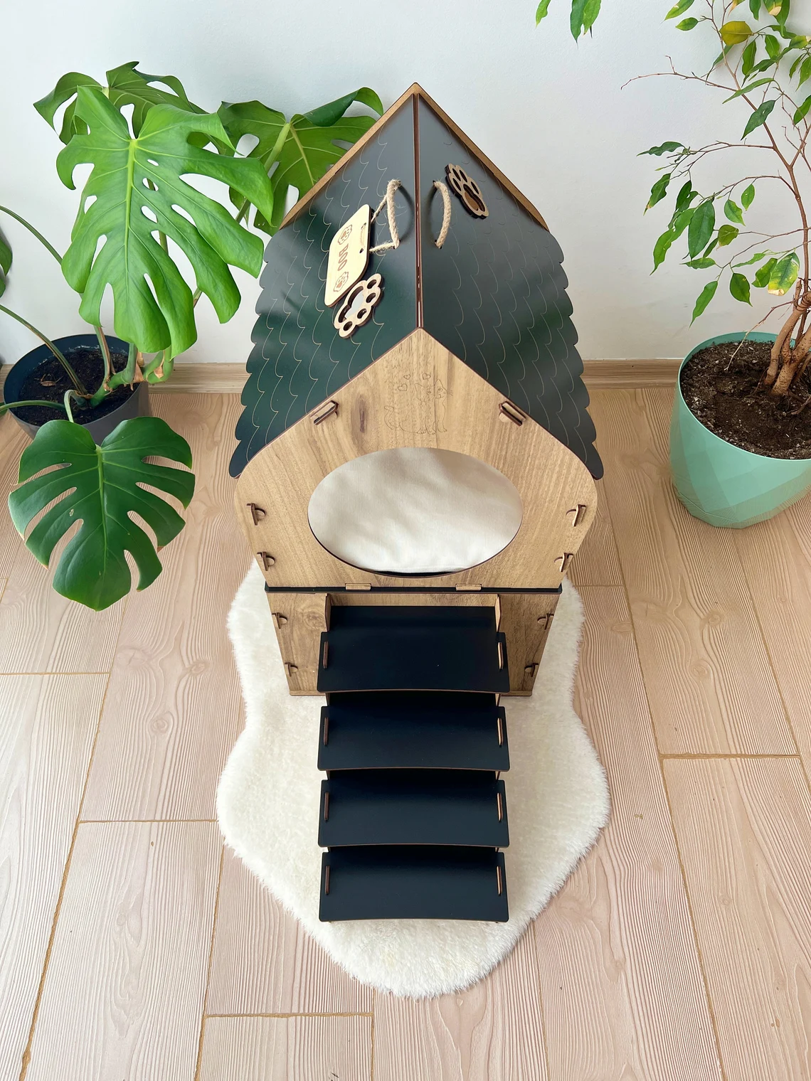 Black and brown medium two-story modern wooden cat house with a front view showing the two levels and entrance.