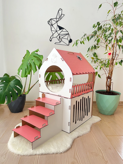 White and pink medium two-story modern wooden cat house with a front view showing the two levels and entrance.