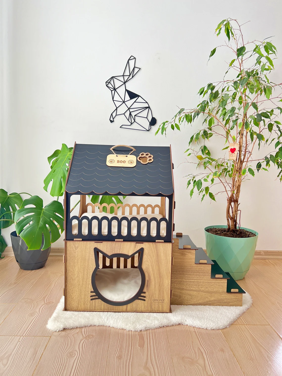 Side view of a black and brown medium two-story modern wooden cat house, highlighting the sleek design and spacious interior.